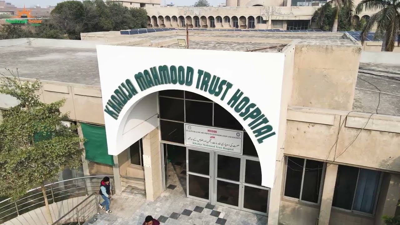Solar panels installed on the canopy and rooftop of a hospital building in Faisalabad