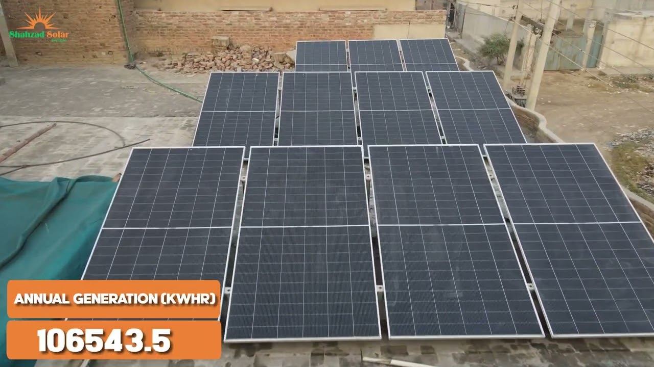 A small rooftop array of roughly twelve solar panels on a flat residential-style roof, not a factory